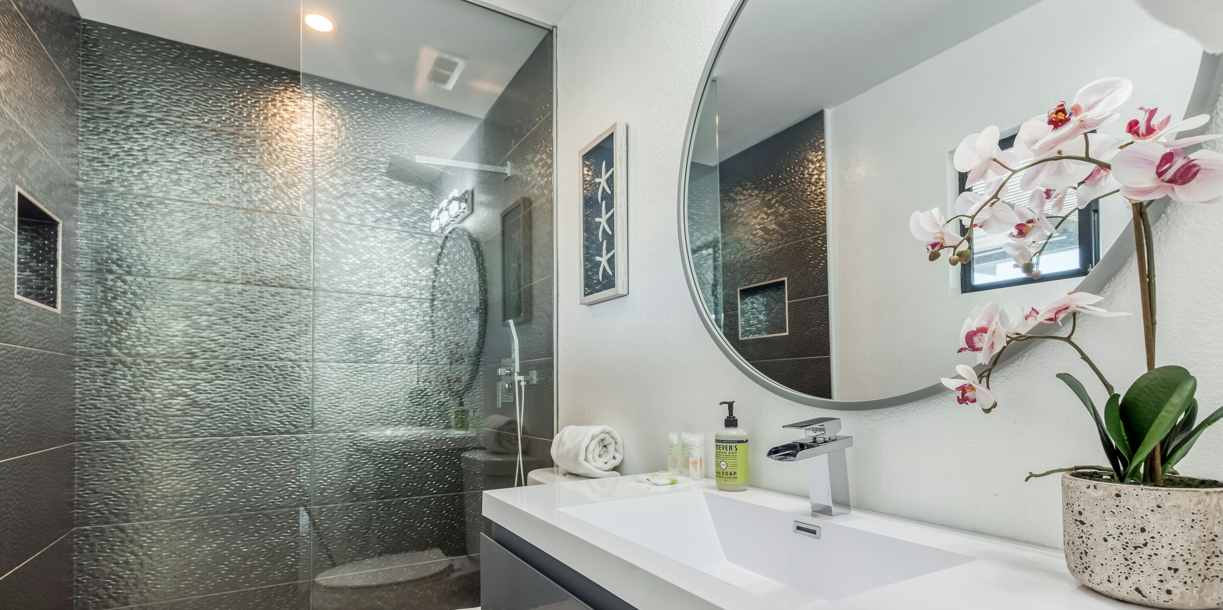 Inside a vacation home bathroom with a glass shower door in Palm Springs, CA